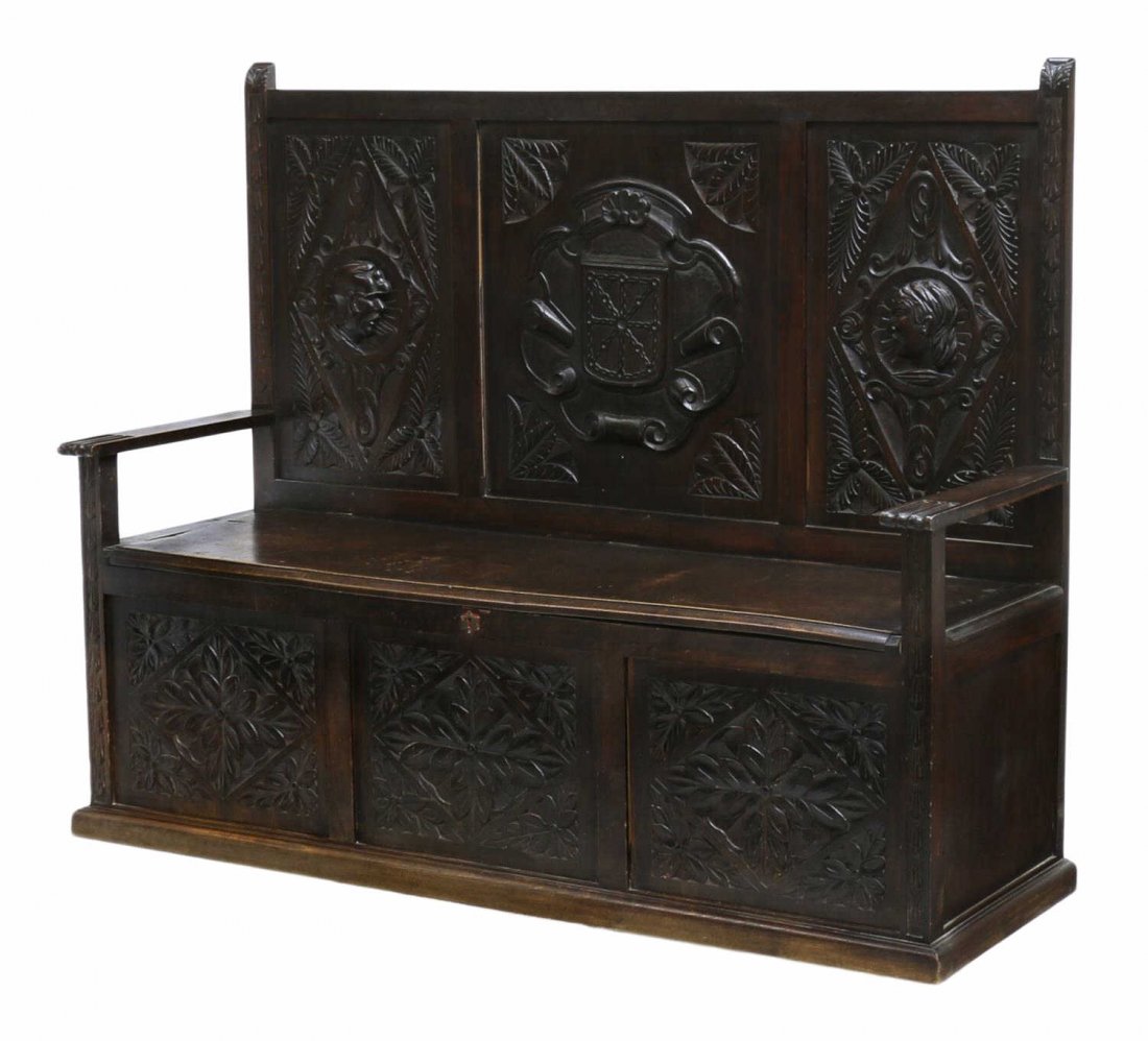 SPANISH LIFT SEAT HALL BENCH: Hall bench, Northern Spain, early 20th c., a high back with figural, foliate and shell carved panels, the seat lifting to storage flanked by squared arms with grooved handholds, foliate carved front p