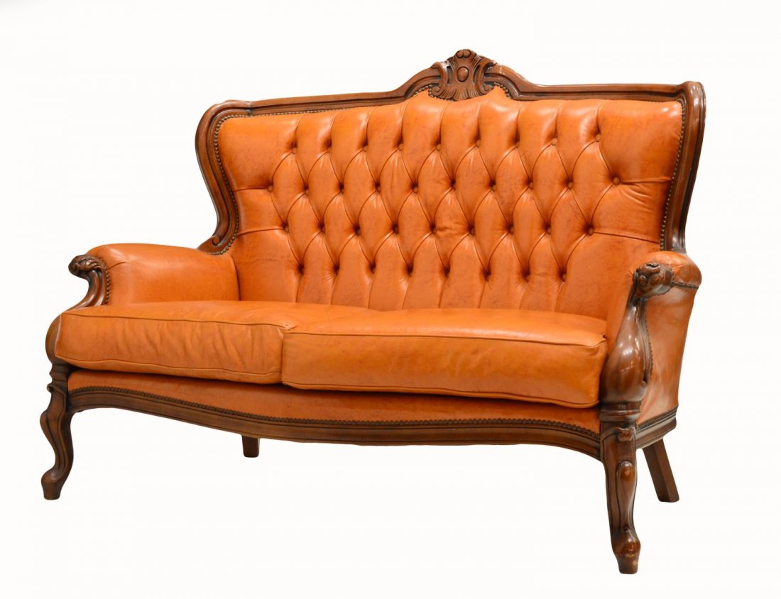LOUIS XV STYLE LEATHER CLUB SETTEE: Italian Louis XV style club settee, 20th c., a floral carved crest rail over the buttoned leather back and arms framing the removable seat cushions, rising on cabriole legs, 41.25"h, 58"w, 27"d Start 