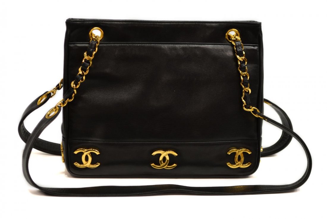 CHANEL GOLD TONE LOGO & BLACK LEATHER PURSE: Chanel shoulder bag in black leather with gold tone hardware, gold tone CC logo to base, black leather interior with two side zipper pockets, magnetic snap closure, double partial gold chain straps wi