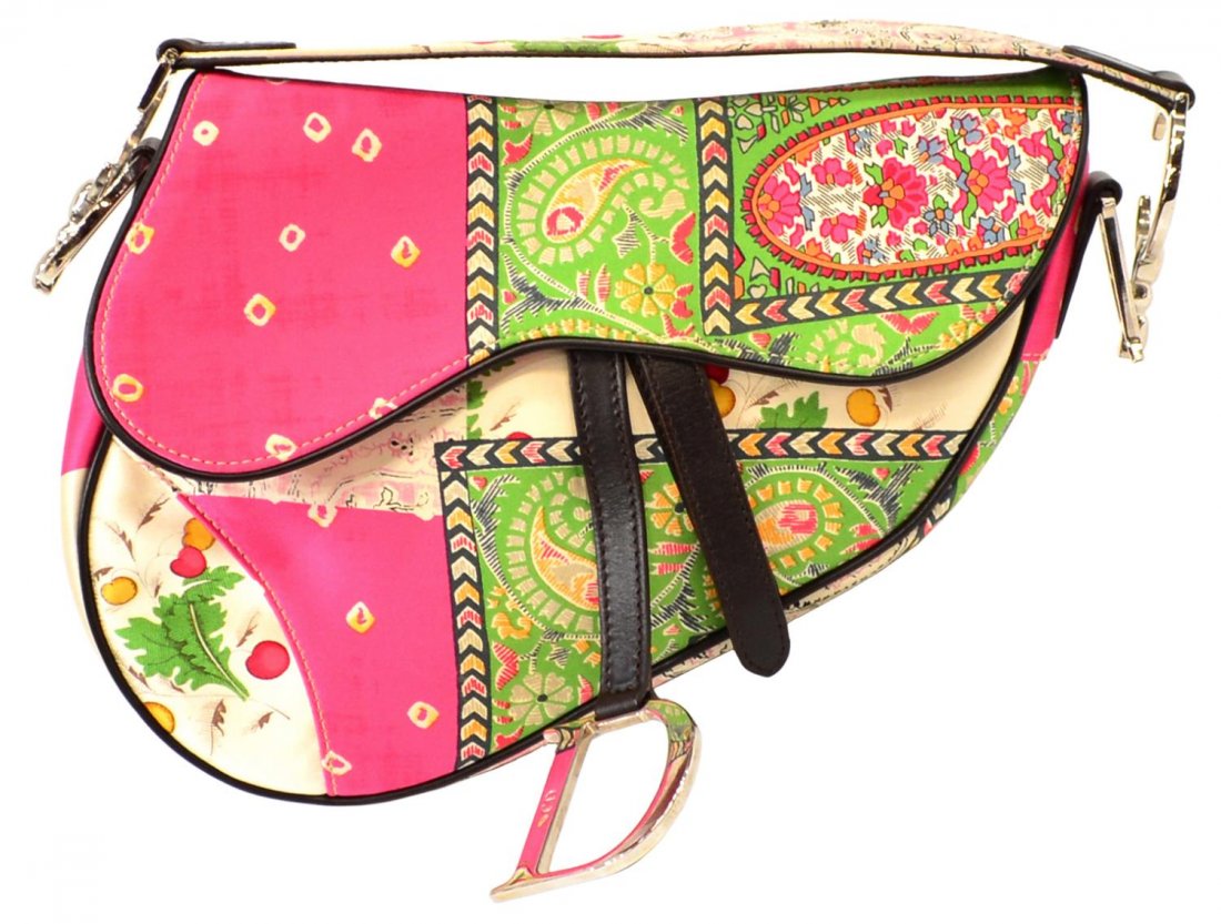 CHRISTIAN DIOR SATIN SILK PAISLEY SADDLE BAG: Christian Dior satin silk saddle bag in pink and green quilted paisley motif, brown leather trim, silver toned hardware, velcro strap opening to brown pattern lined interior with single zip pocket, ba