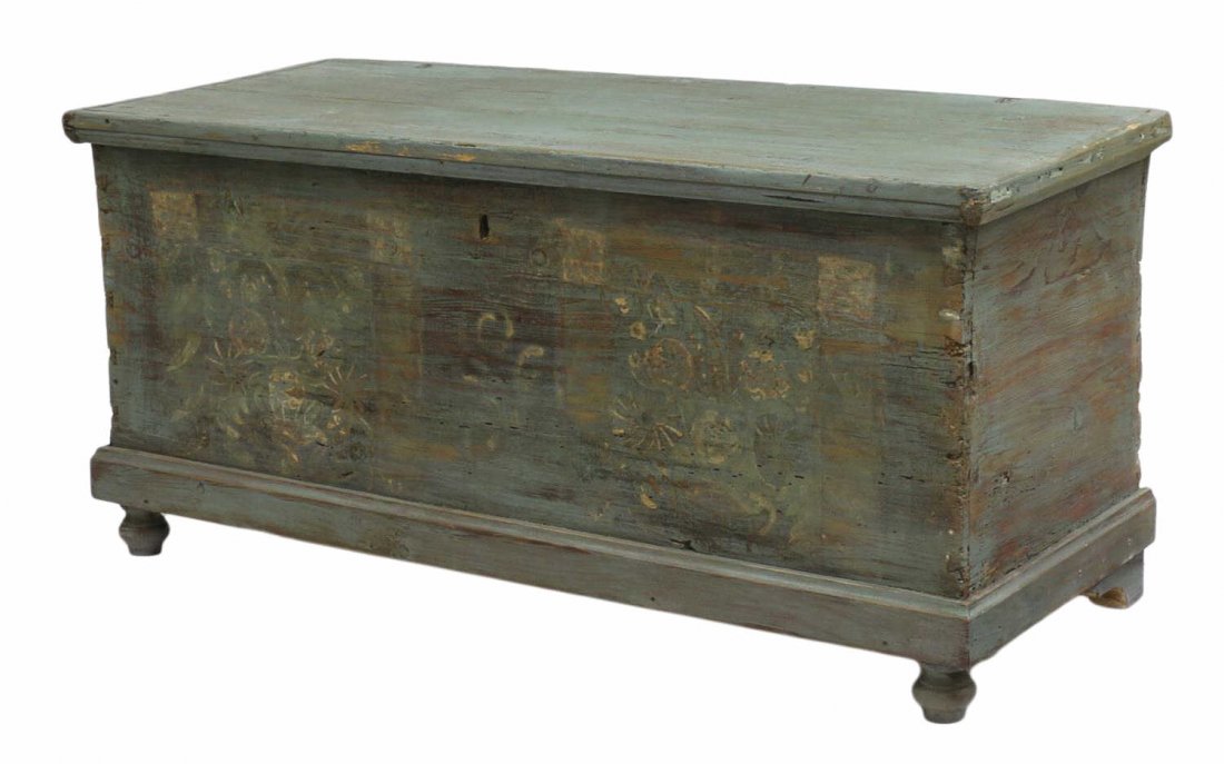SCANDINAVIAN PAINTED PINE TRUNK: Scandinavian pine trunk, 19th c., a faded paint finish with remnants of floral decoration at front, corner dovetail joinery, raised on bun feet, 22"h, 47"w, 19.5"d Start Price: $150.00