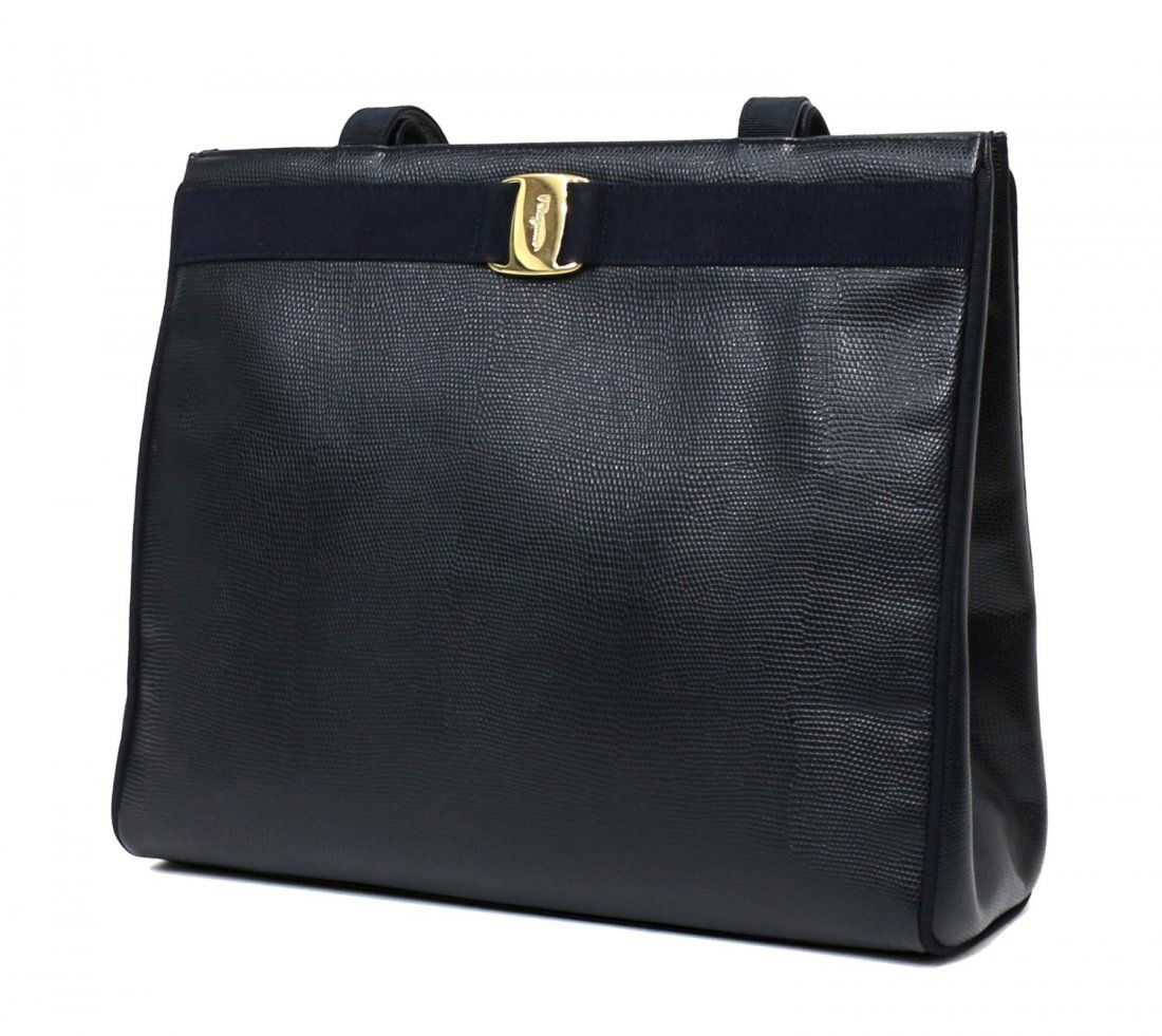 SALVATORE FERRAGAMO VARA LEATHER SHOULDER TOTE BAG: Salvatore Ferragamo "Vara" shoulder tote bag in navy leather embossed in a reptilian pattern, gold tone hardware, two magnetic snaps opening to a black lined interior with a zip side pocket, bag: appr