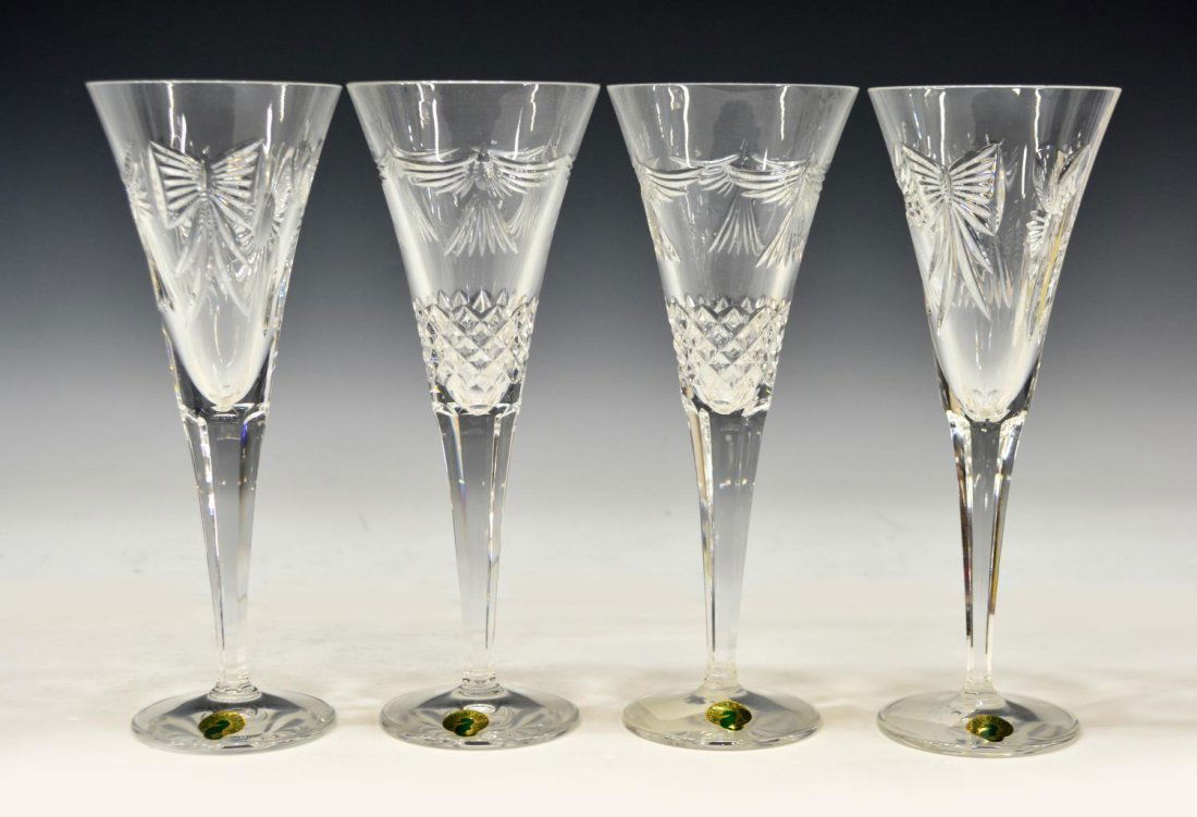 (4) WATERFORD CRYSTAL MILLENIUM TOASTING FLUTES: (set of 4) Waterford cut crystal toasting flutes, from the Millenium Collection, cut with bows, hearts, stylized birds and bundles of wheat, each marked on base and retaining label, approx 9"h, 3.25lb
