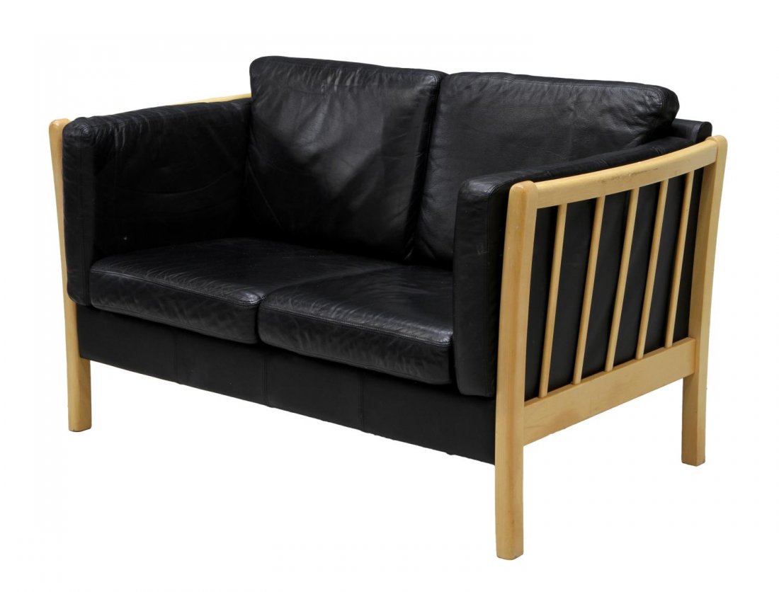 DANISH MID-CENTURY MODERN BLACK LEATHER SOFA: Danish mid-century modern black leather upholstered love seat, a beech wood frame around the two seat sofa, removable side, back and seat cushions, rising on square legs, approx 36.25"h, 55"w, 31.25"d