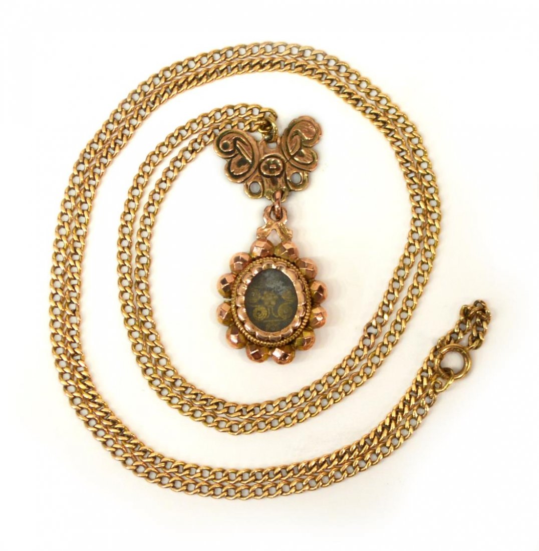 LADIES ESTATE 14KT ROSE GOLD LOCKET NECKLACE: Ladies estate 14kt rose gold necklace with pendant, double sided oval pendant having oval glass over filigree floral design, surmounted by a cut butterfly, approx 25.5"l, 14 grams (all inclusive) Star