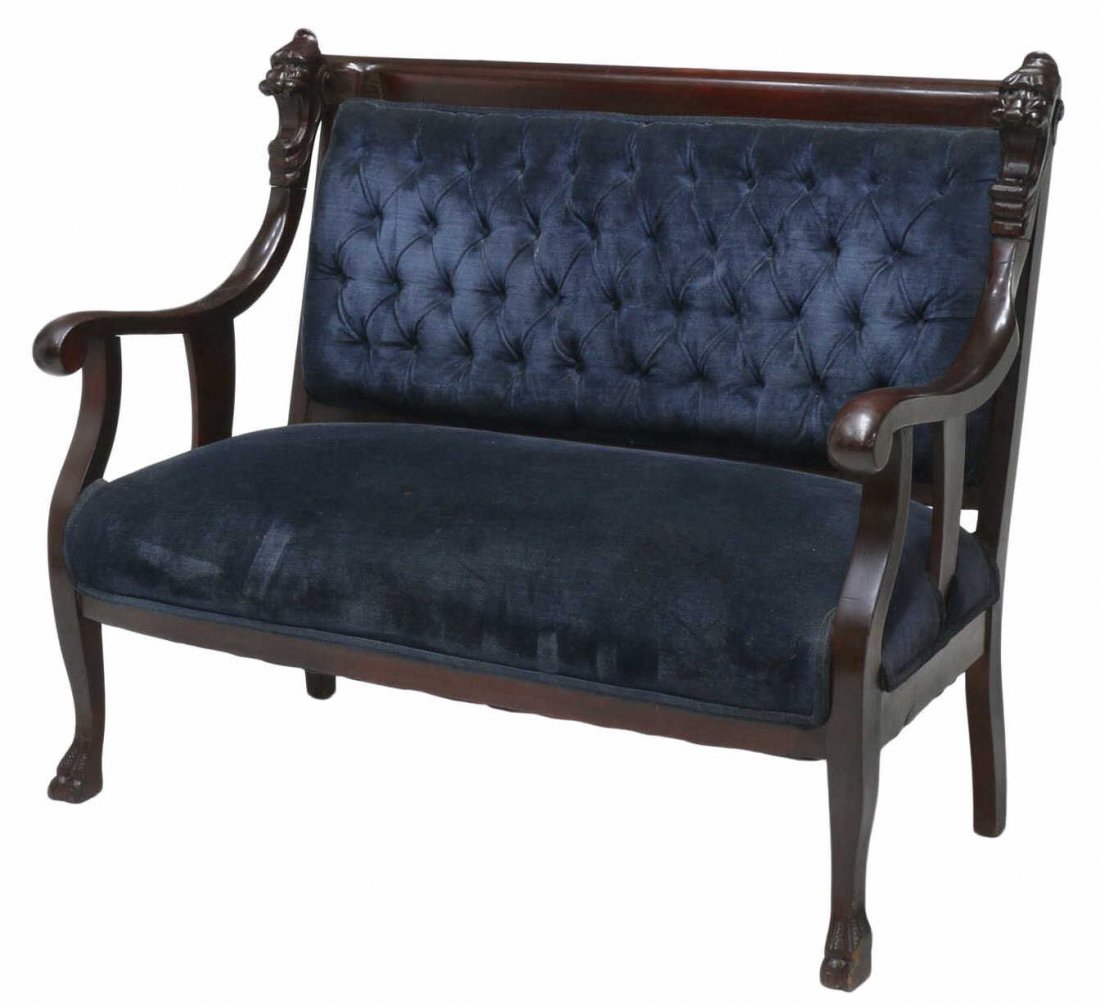 AMERICAN SETTEE, LIONS HEADS, PAW FEET, BUTTONED: American mahogany settee, 19th century, a rolled crest rail with carved open mouth lions heads at each end extending downward to the arms with scrolled handholds, the back with blue buttoned upholster
