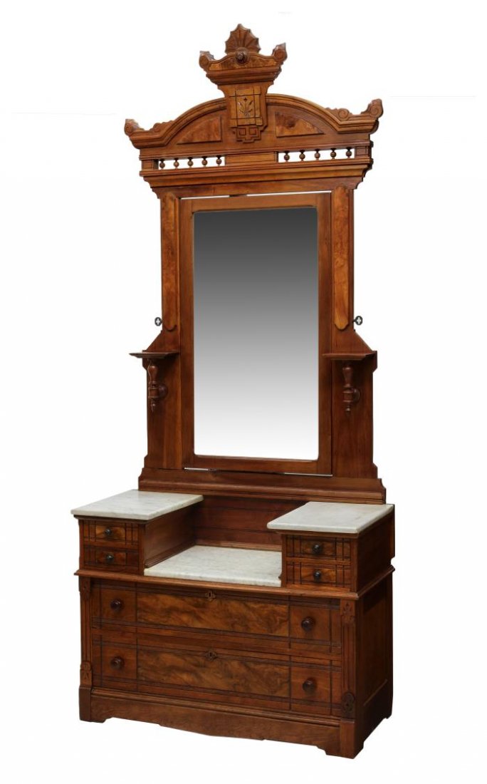 AMERICAN RENAISSANCE REVIVAL DROP CENTER DRESSER: American Renaissance Revival dresser, 1880's, having an arched cornice over a drop center tilting mirror flanked by candle stands, marble tops at the center and two side pedestals, short drawers over 