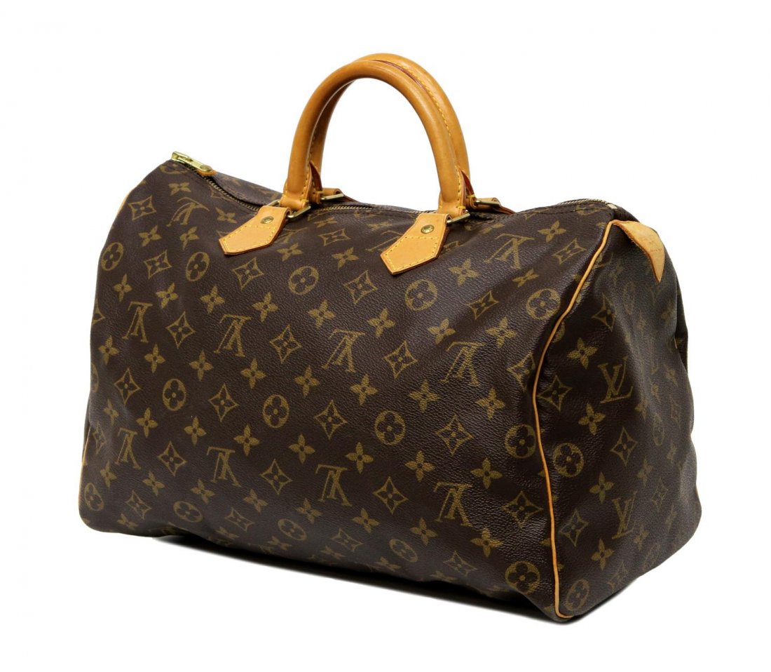 LOUIS VUITTON MONOGRAM CANVAS SPEEDY HANDBAG: Louis Vuitton "Speedy 35" handbag in monogram canvas, leather handles, piping and trim, gold tone hardware, single zip opening to canvas lined interior with slot pocket, main zipper lacking leather pu