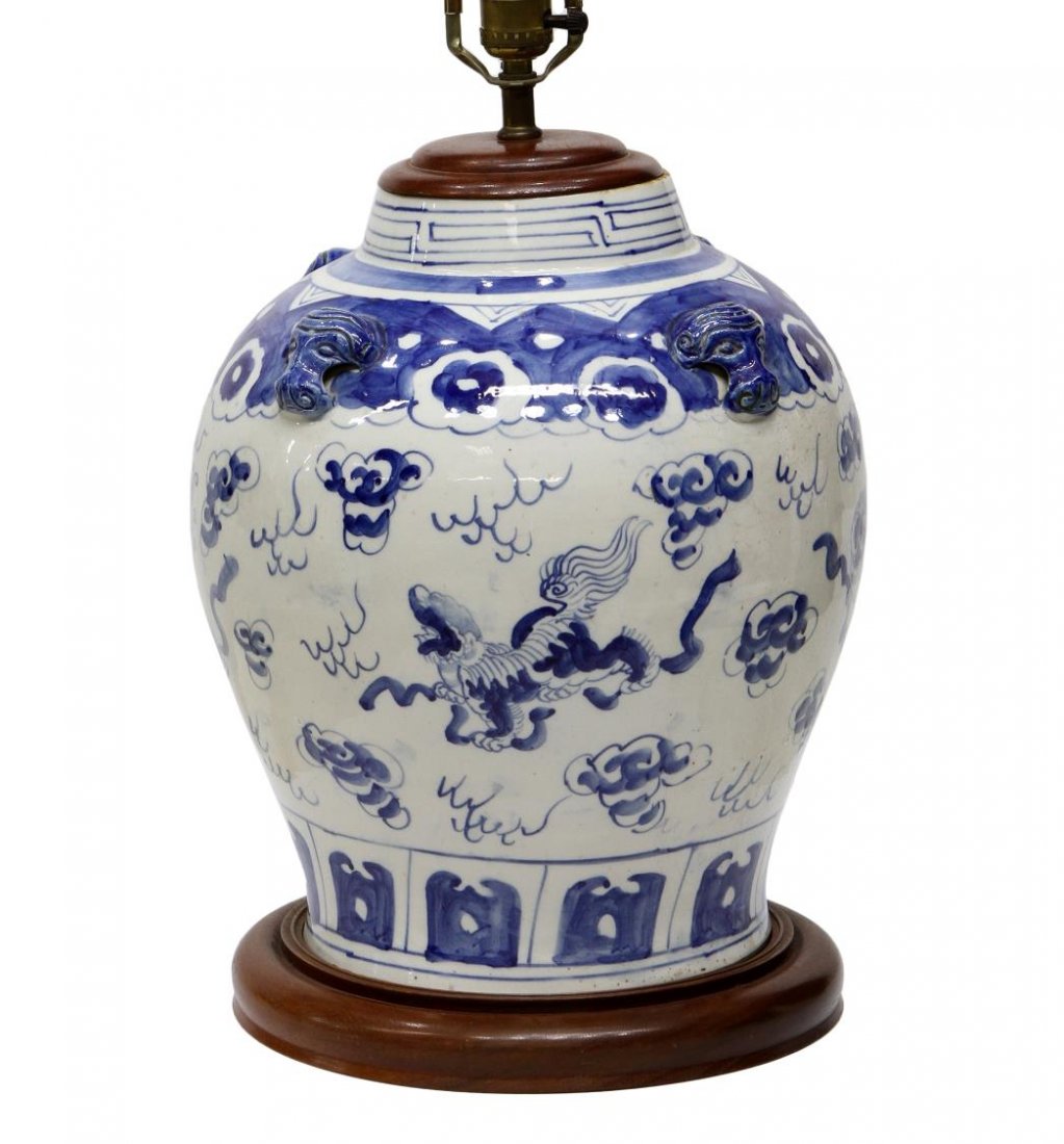 LARGE CHINESE BLUE & WHITE GINGER JAR TABLE LAMP: Chinese underglaze blue and white porcelain vase, now mounted as a table lamp, depicting mythical 'qilin' beasts among clouds, rising on a circular wooden base, oval shaped blue stone finial, 33"h, 17