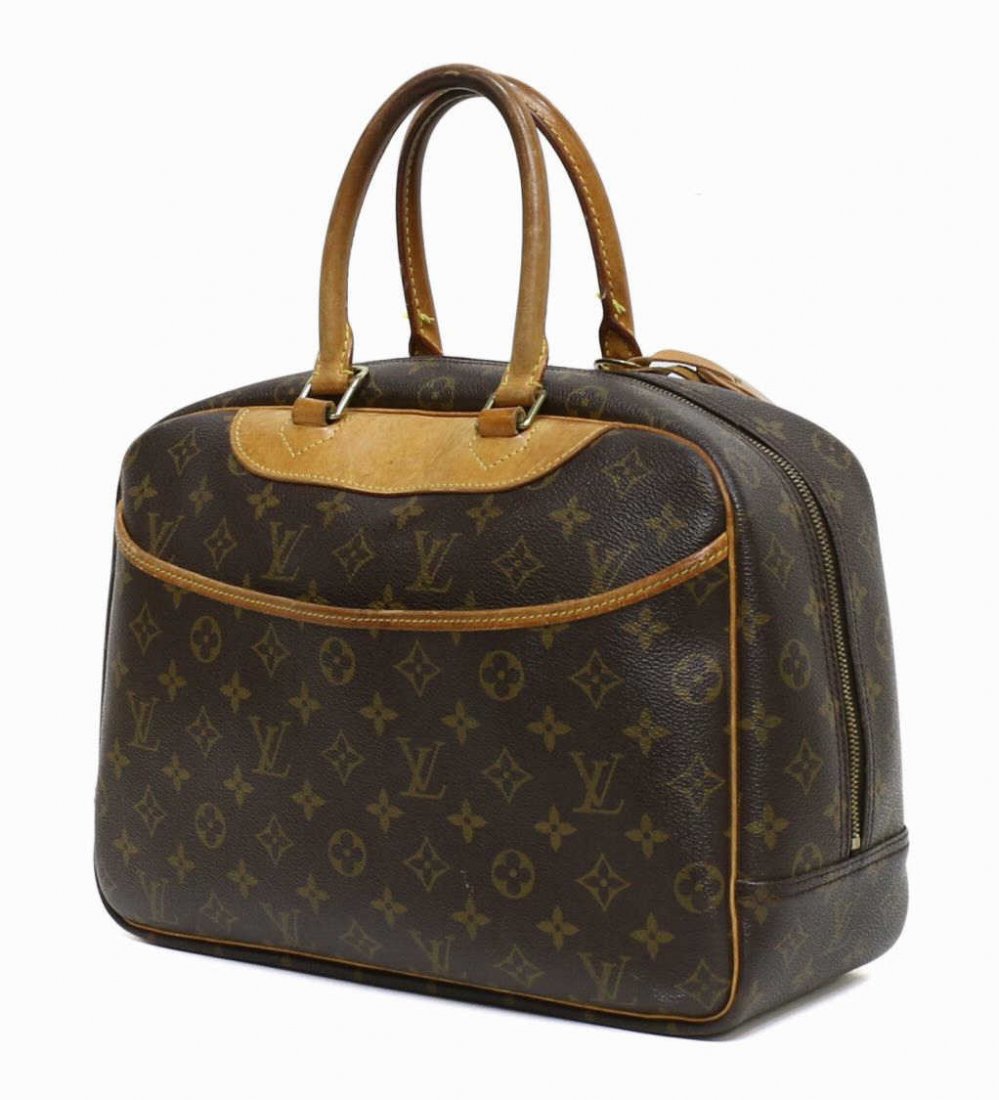 LOUIS VUITTON DEAUVILLE MONOGRAM CANVAS HANDBAG: Louis Vuitton "Deauville" handbag in monogram canvas, leather handles, piping and accents, luggage tag and lock, full length exterior slip pocket, dual zip opening to canvas lined interior with four s