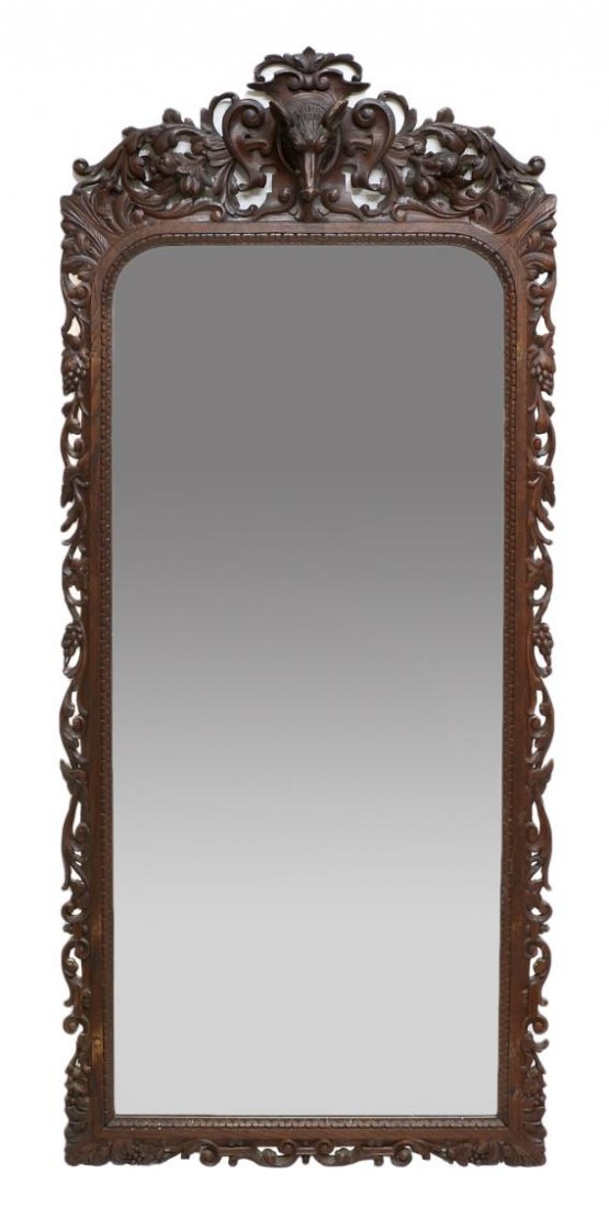 RENAISSANCE REVIVAL WILD BOAR CARVED WALL MIRROR: Renaissance Revival carved oak wall mirror, Barcelona, Spain, 19th c., a pierced foliate crest centering carved wild boar's head within a cartouche, over the acanthus and grape vine rectangular frame