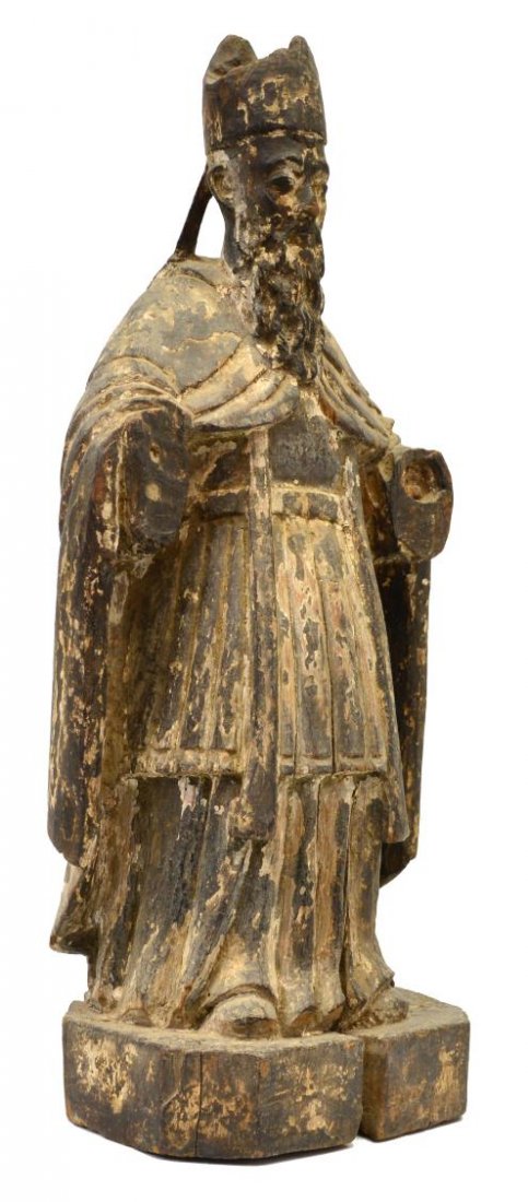 ANTIQUE SPANISH COLONIAL CARVED WOOD SANTOS STATUE: Spanish colonial carved wood religious figure, 19th c., saint wearing bishop head dress rising on an octagonal base, remnants of polychrome decor, approx 19.25"h, 6lbs Start Price: $100.00