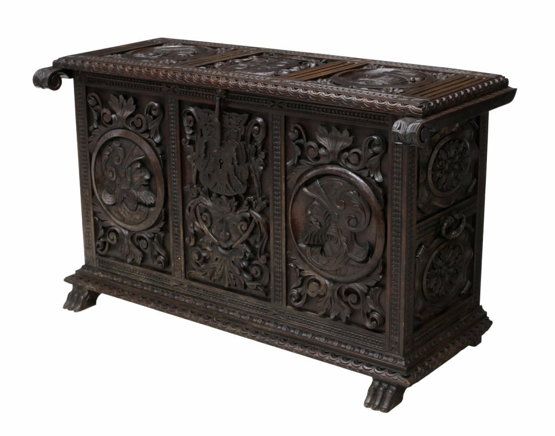 ELABORATELY CARVED TRUNK, SPAIN, 19TH C.: Spanish 19th c. trunk, Barcelona, elaborate relief carving including figures, foliage and armorial depictions, a strap hinged top opening to the interior, the front lockplate formed with a double head