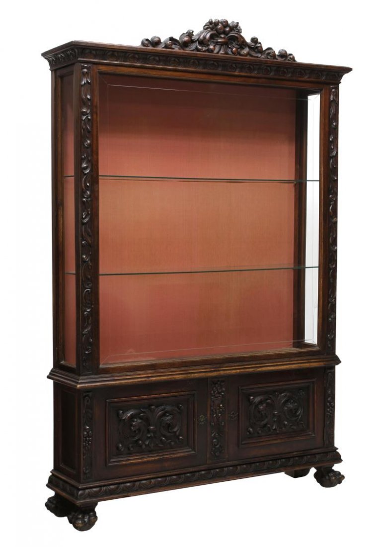 SPANISH BAROQUE CHINA DISPLAY CABINET: Spanish Baroque china display cabinet, 19th c., a foliate center crest with stepped cornice over the glass front and sides display area, side doors open to glass shelves, two lower doors embellished w