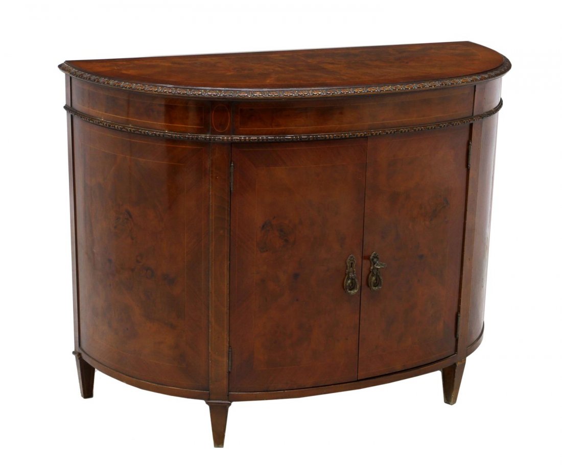 SPANISH BURLWOOD INLAID DEMILUNE CABINET: Burlwood inlaid demilune cabinet, Northern Spain, 20th c., having two doors, ornamental escutcheon plates with teardrop pulls, opening to shelved storage, all rising on tapered supports, approx 33.75"