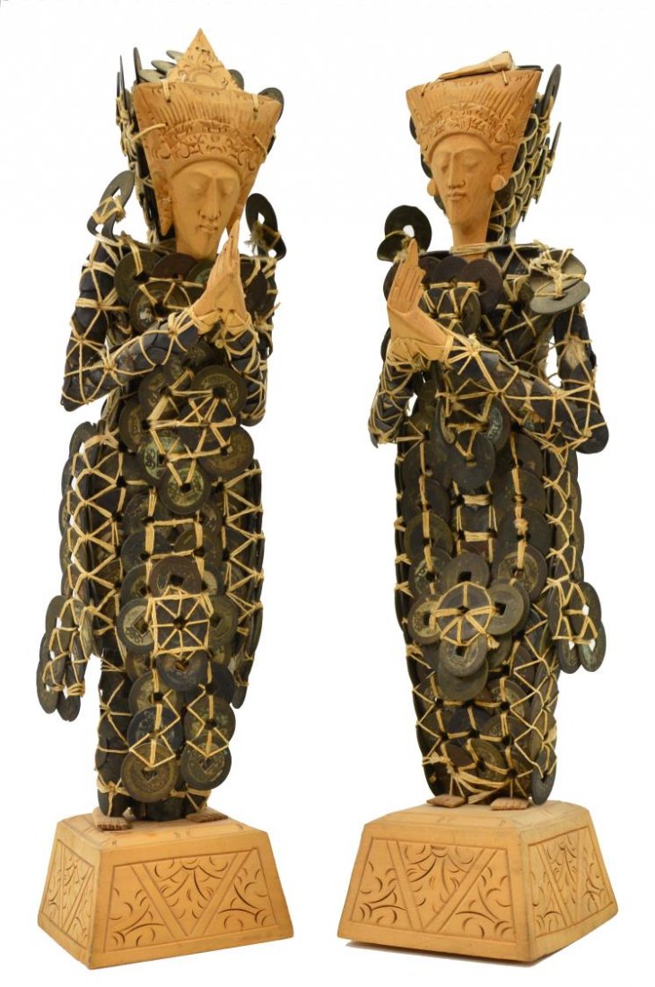 (2) SOUTHEAST ASIAN CARVED WOOD & COIN FIGURES: (pair) Antique Southeast Asian figures, each with carved wood face, hands and feet, body fashioned from tied Chinese coins, standing on a carved plinth, approx 15.25"h, 6.5lbs total Start Price: $50.0