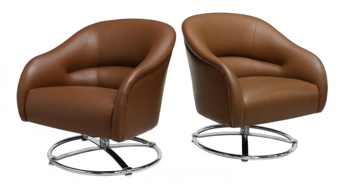 (2)MODERN SWIVEL CHAIRS, WARD BENNETT FOR BRICKELL: (lot of 2) Swivel lounge chairs, design by Ward Bennett (American, 1917-2004) for Brickell Associates, a barrel form chair upholstered in brown leather, rising on four extended chrome steel legs joine