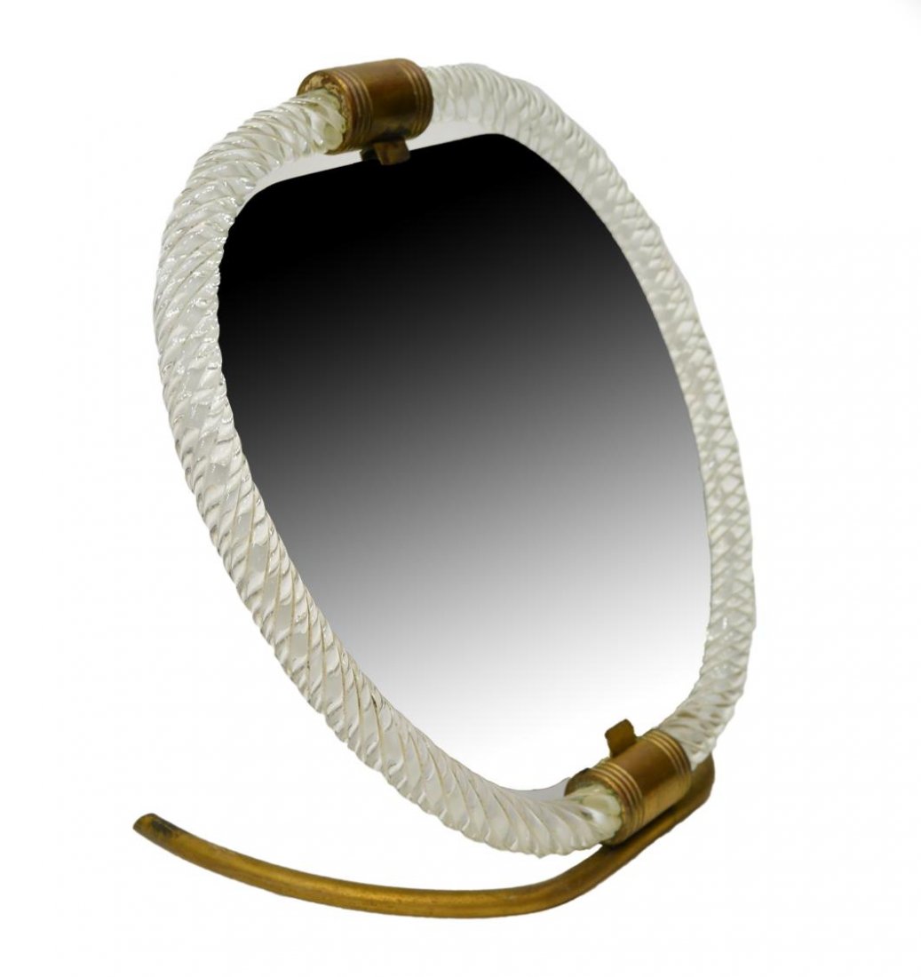 VENINI MURANO FRAMED TABLE MIRROR: Venini Murano table mirror, Italy, 1940's, the mirror plate framed by two brass joined twist glass tubes, rising on a brass base, made in Italy tag at backside, overall: approx. 9"h, 9"w, 5.25"d Start