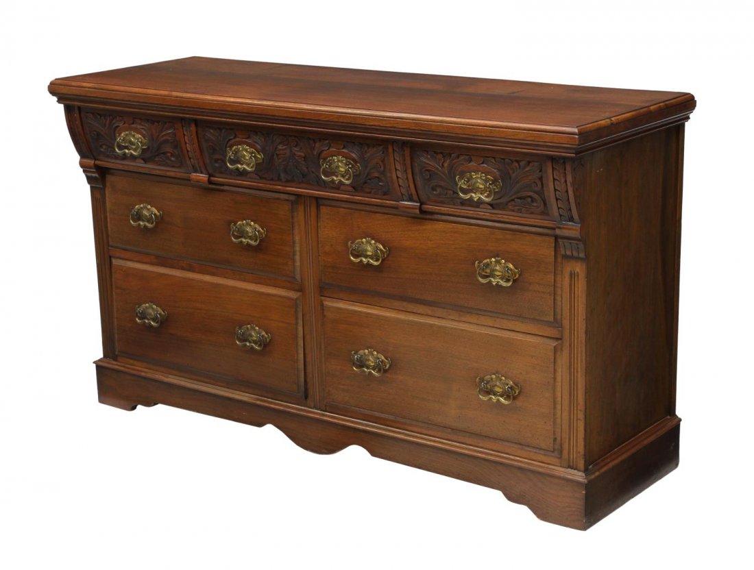 EDWARDIAN CARVED MAHOGNAY SIDEBOARD: Edwardian mahogany sideboard, England, early 20th c., the rectangular top over three canted faced foliate relief carved drawers, one with removable cutlery trays, four lower drawers, all rising on bra