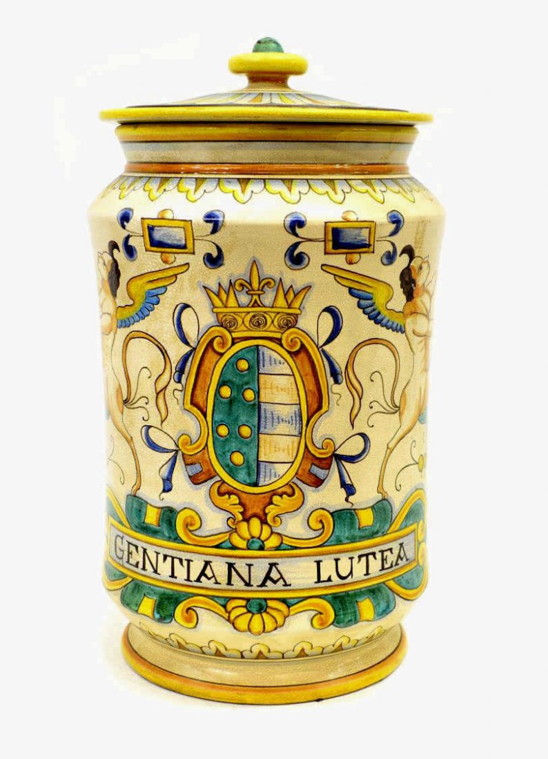 ITALIAN DERUTA MAJOLICA COVERED JAR, SIGNED: Italian maiolica polychrome ceramic covered jar, Deruta, crest flanked by winged figure with tail, labeled 'Gentiana Lutea', crazing throughout, base marked Dip. A Mano Cassetta G. Deruta, approx 18"h