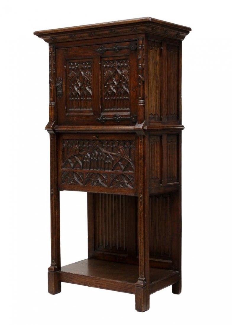 CONTINENTAL GOTHIC STYLE CARVED OAK HALL CABINET: Continental carved oak cabinet, Belgium, 19th c., in the Gothic taste with tracery and linen fold carving throughout, upper case having a single door opening to another door with pierce carving (does 