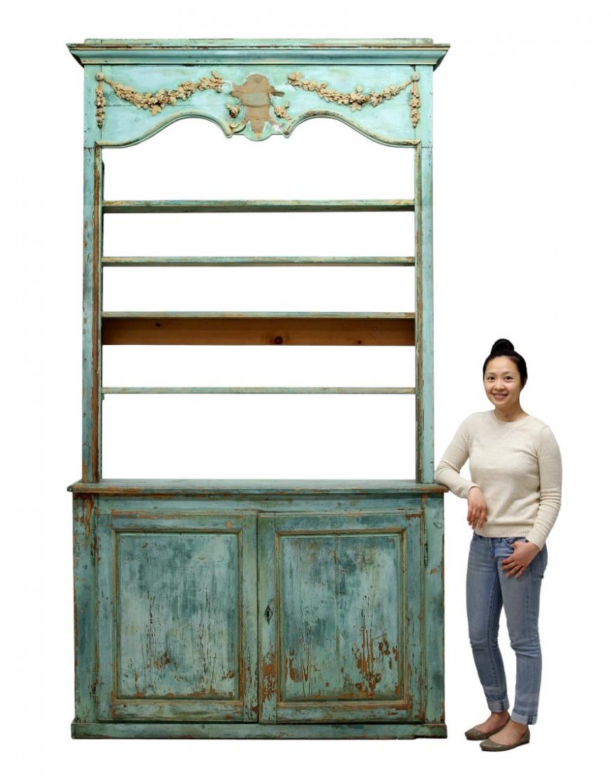 LOUIS XVI STYLE PAINTED BOOKCASE: Louis XVI style bookcase, 19th c., finished in worn green paint, a protruding cornice over the frieze decorated with applied foliate garlands and lacking the central embellishment, four adjustable hei