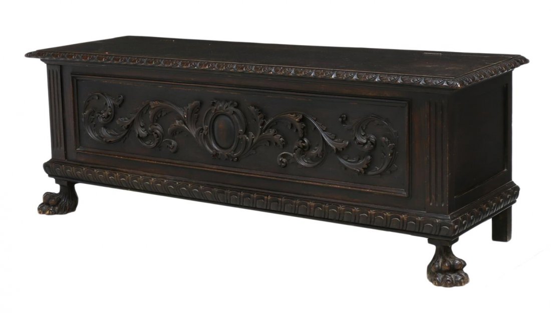 RENAISSANCE REVIVAL FOLIATE STORAGE CHEST / BENCH: Italian Renaissance Revival carved storage chest / hall bench, the long rectangular case with lift top having ornamental carved border, the facade detailed with scrolled foliates, rising on paw form f