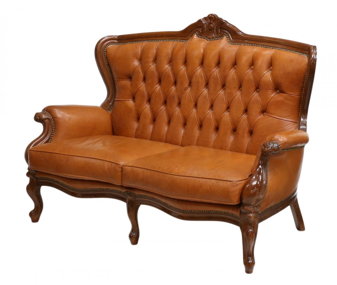 ITALIAN LEATHER UPHOLSTERED BUTTON BACK SOFA: Italian leather upholstered sofa having carved wood frame, tufted button back over two loose cushion seats, raised on cabriole legs, approx 41"h, 57"w, 23"d Start Price: $200.00