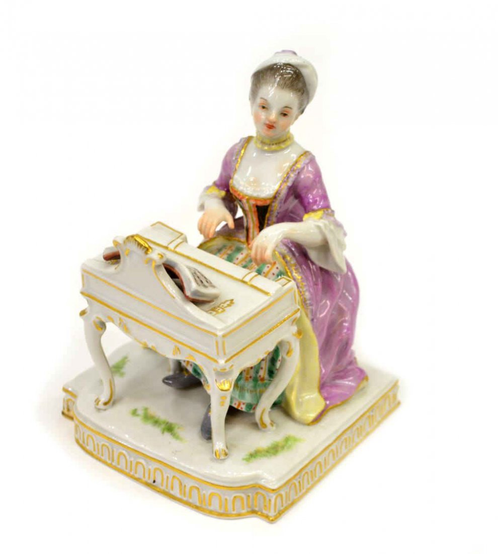 MEISSEN PORCELAIN FIGURE EBLEMATIC OF "HEARING": Meissen porcelain figure, "Hearing", from the five senses series modeled by by J.C.Schoenheit, depicting a seated lady poised to play the harpsichord, her elegant dress painted with flowers and trimme