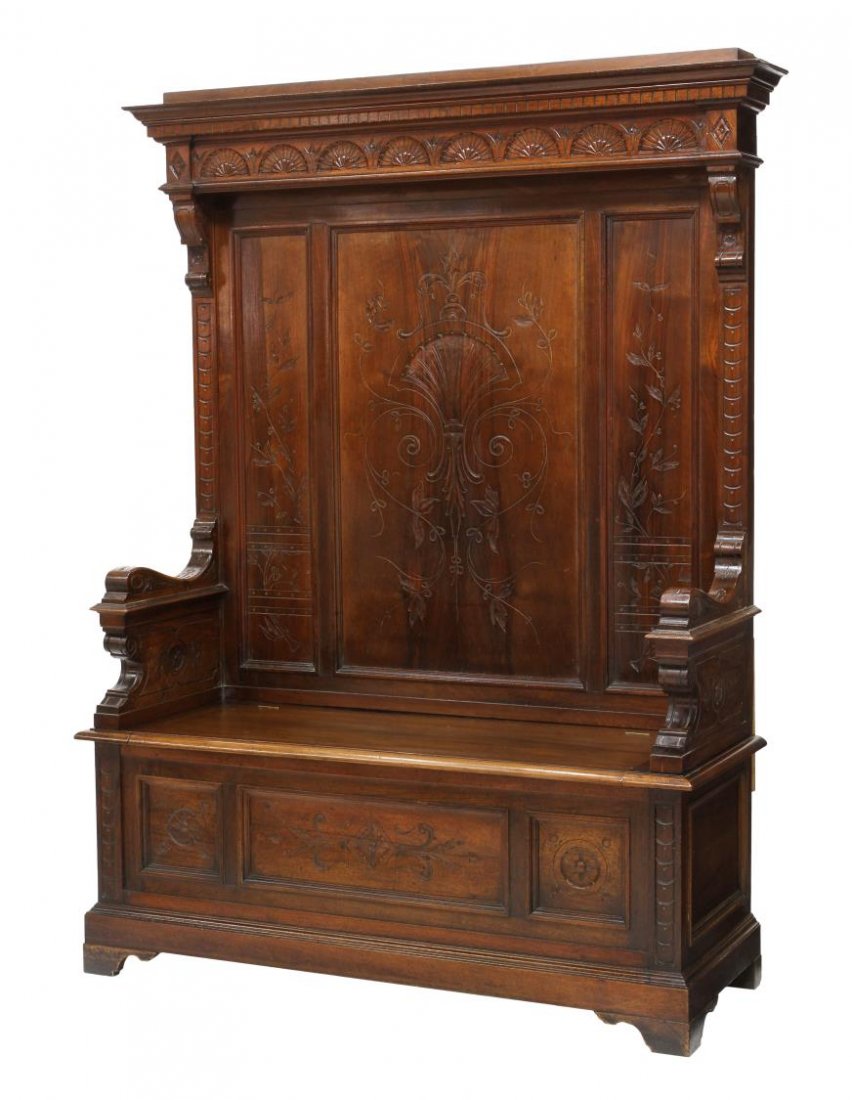 RENAISSANCE REVIVAL CARVED WALNUT HALL BENCH: Italian Renaissance Revival highback hall bench, 19th c., ornamental trim and fan carved frieze surmounting the paneled back with incised carving, lift seat opening to storage, flanked by substantial 