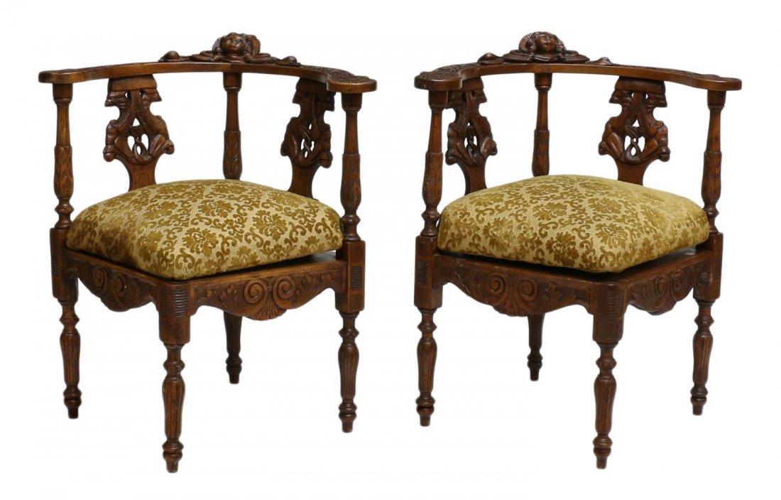 (2) FRENCH FOLIATE & FIGURAL CARVED CORNER CHAIRS: (pair) French carved corner chairs, 19th c., the foliate carved curved crest rail centered by a relief mask of child in bonnet, double bird splats over the padded and upholstered removable seat, raise