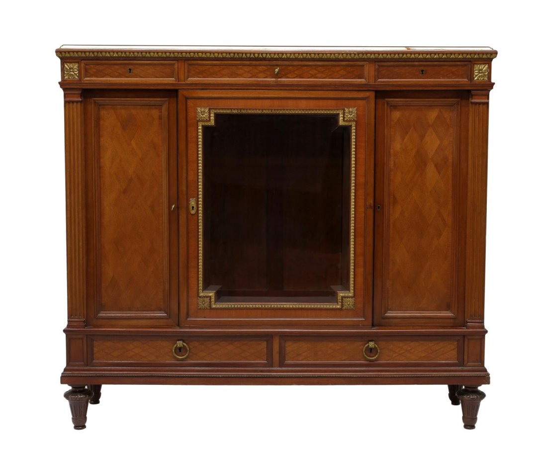 GOOD QUALITY FRENCH LOUIS XVI STYLE SIDEBOARD: French Louis XVI style sideboard, early 20th c., having an inset marble top over three frieze drawers, a central glazed door with flanking doors, two lower drawers, rising on short turned and ribbed l