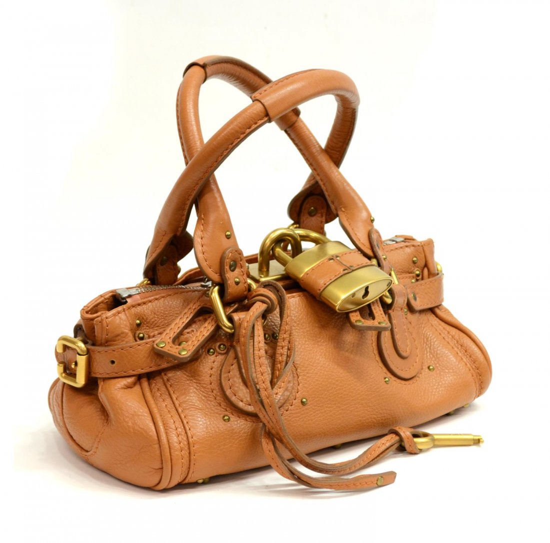 CHLOE PADDINGTON PM TAN GRAINED LEATHER HANDBAG: Chloe "Paddington PM" handbag in tan grained leather with two straps, gold brushed hardware, two exterior slot pockets, beige cloth interior featuring cell and zipper pocket, on small metal feet, acco
