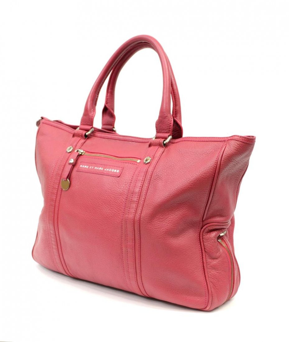 MARC JACOBS RASPBERRY GRAINED LEATHER PURSE: Marc by Marc Jacobs raspberry grained leather tote bag with two handles, silver tone pull tag, pink and black cloth lined interior with two slip and one zipper pocket, dust bag, minor surface wear, ba