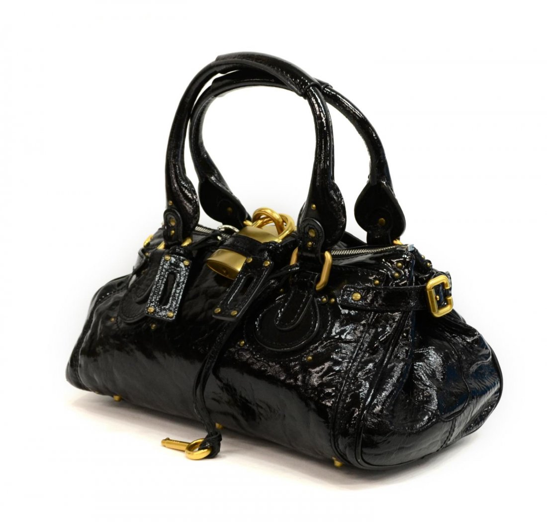 CHLOE BLACK PATENT LEATHER PADDINGTON MM PURSE: Chloe "Paddington MM" handbag in black patent leather with two straps, brushed gold tone hardware, exterior slot pocket, black cloth interior with cell and zipper pockets, on small metal feet, accompa