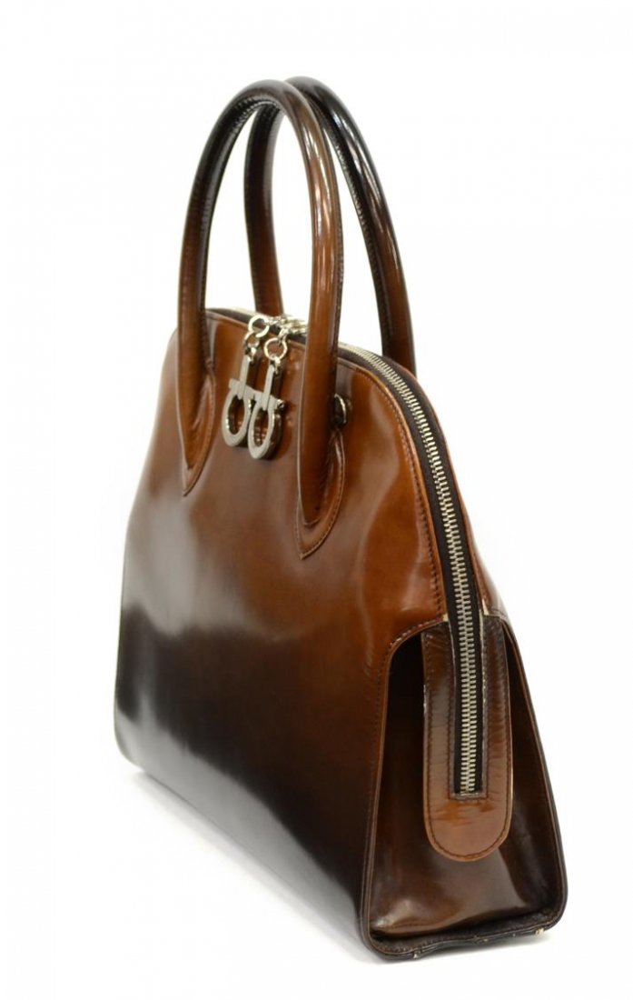 SALVATORE FERRAGAMO GRADIENT LEATHER HANDBAG: Salvatore Ferragamo leather handbag in brown to black gradient with two matching leather handles, silver tone hardware, zipper top opens to black logo pattern cloth interior divided into two sections,