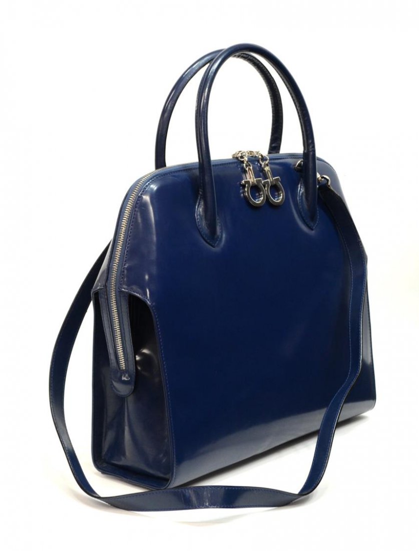 SALVATAORE FERRAGAMO BLUE PATENT LEATHER HANDBAG: Salvatore Ferragamo handbag in blue patent leather with two matching handles, silver tone hardware, zippered top opens to black cloth interior divided into two sections with single zipper pocket, incl