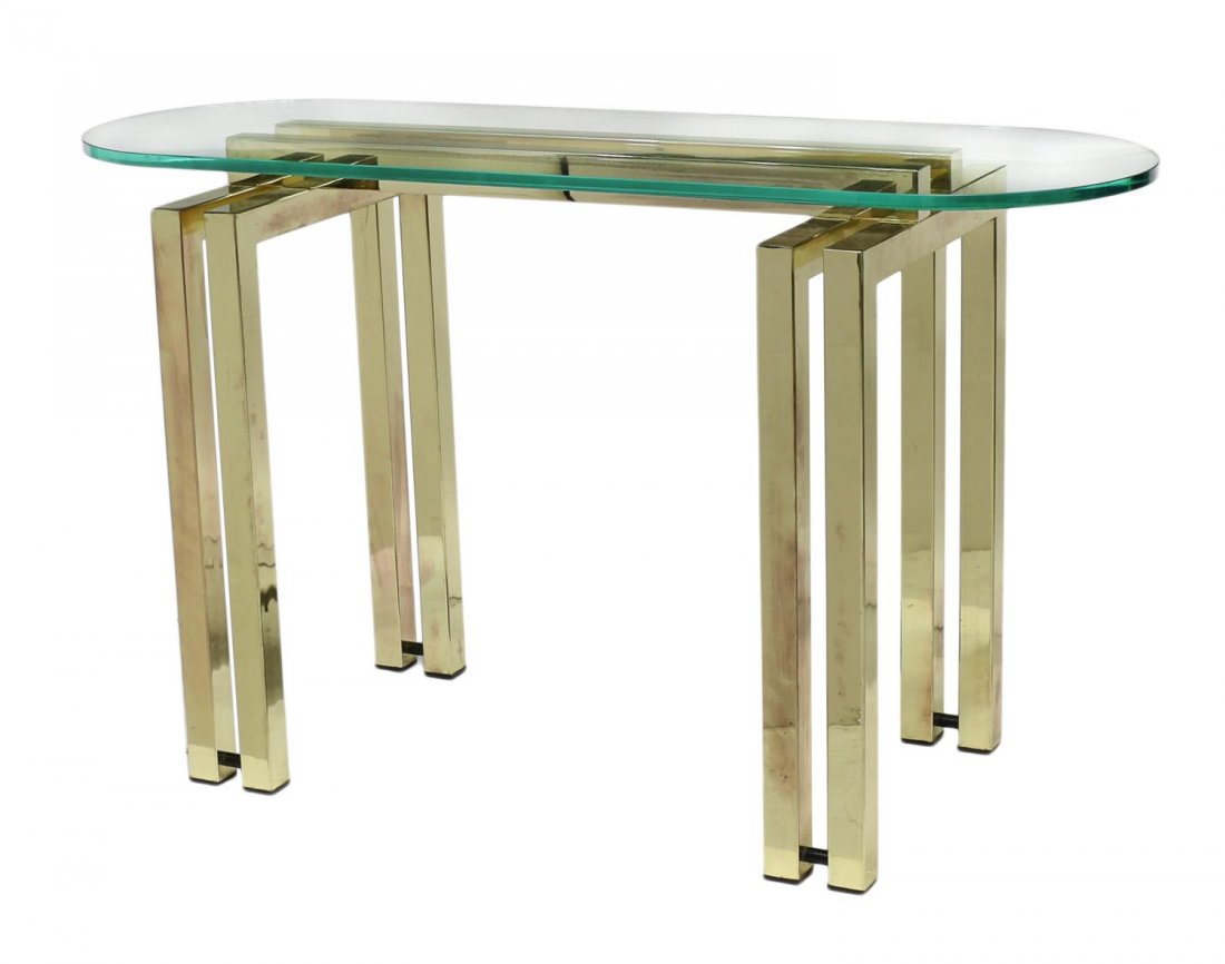 ITALIAN MODERN GLASS & GILT STEEL SOFA TABLE: Italian modern sofa table in the manner of Maison Jensen, c. 1970, an oval glass top resting on the gilt steel base with double square legs at each end, 27.5"h, 48"w, 17.5"d Start Price: $150.00