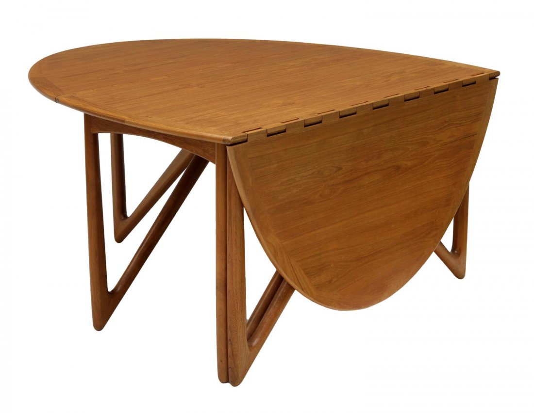 DANISH MODERN KURT OSTERVIG TEAK DINING TABLE: Danish modern teakwood dining table, design by Kurt Ostervig (Denmark, 1912-1986), the oval top and leaves joined with large exposed wood hinges, rising on angular turned legs, open: 76.5"l, leaves do