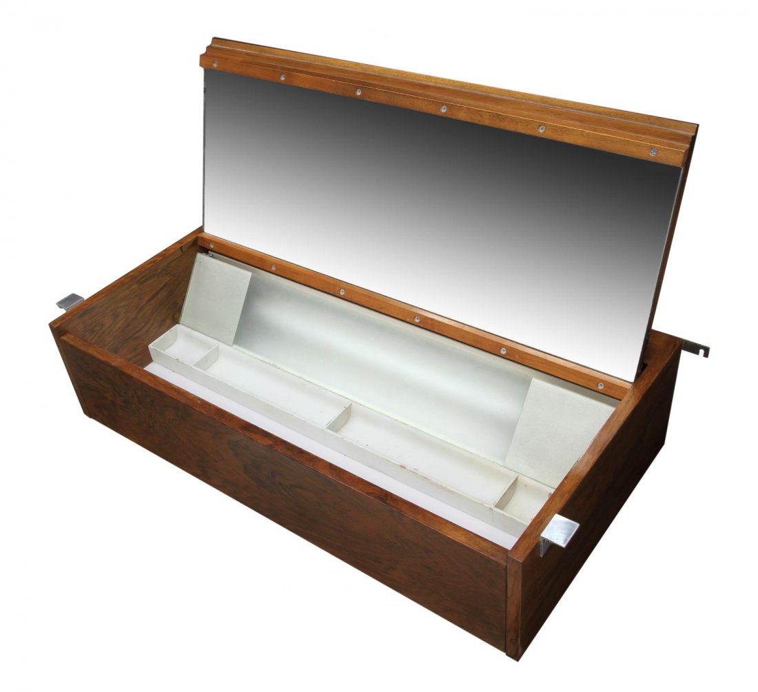 GEROGE NELSON FOR HERMAN MILLER VANITY CENTER: Lighted hanging rosewood wall vanity center cabinet, design by George Nelson (American, 1908-1986) for Herman Miller, door opens to lighted mirrored interior, 8"h, 37"w, 18.25"d Start Price: $80.00