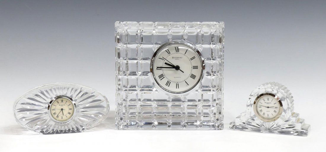 (3) WATERFORD CUT CYRYSTAL DESK / TABLE CLOCKS: (lot of 3) Waterford cut crystal clocks: (1) small oval quartz clock, maker marked on face, approx 2.5"h, 4.75"l; (1) square quartz clock, approx 5.5"h; (1) small mantel quartz clock, approx 2.5"h, 4"