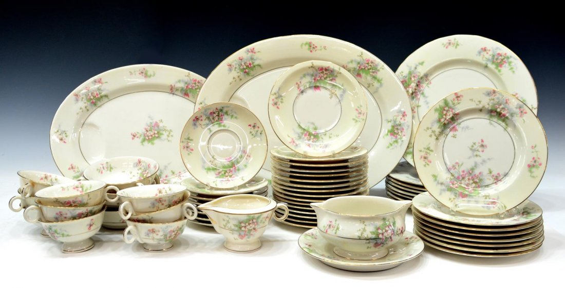 (57) T. HAVILAND APPLE BLOSSOM DINNER SERVICE: (lot of 57) Theodore Haviland porcelain dinner service, New York, in the 'Apple Blossom' pattern, pink flowers having pale green and blue foliage on a cream ground with gilt trim, each marked on base,