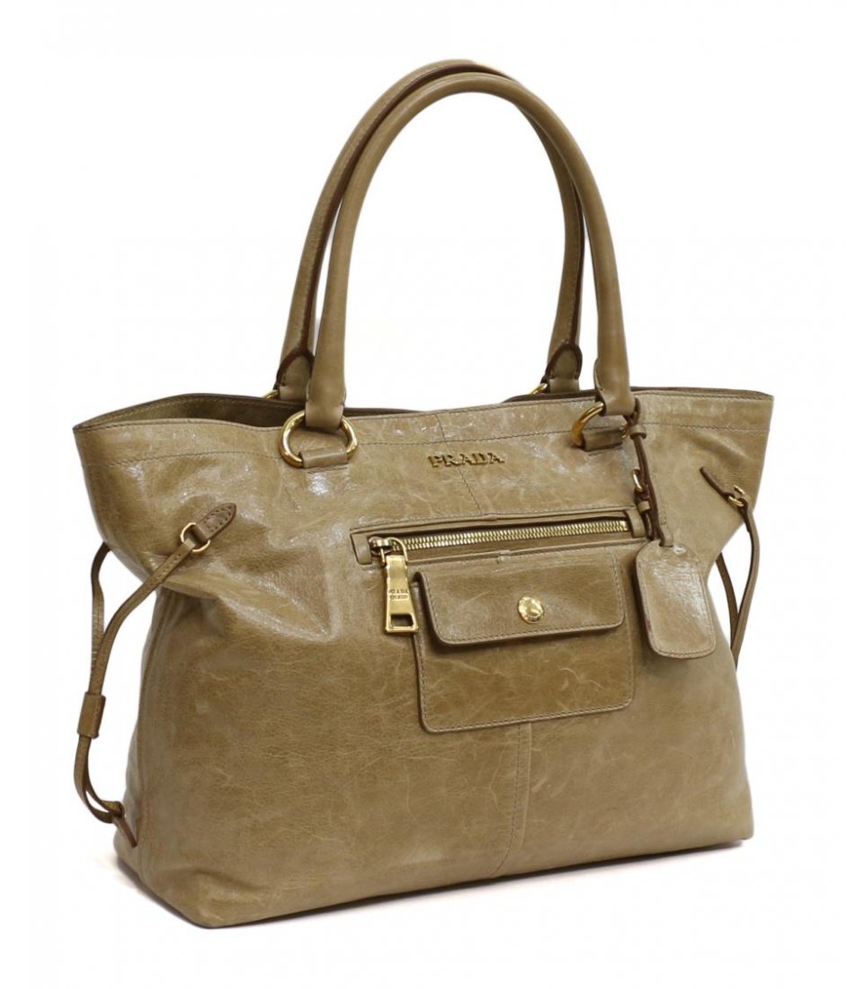 PRADA "VITELLO SHINE" BROWN DISTRESSED LEATHER BAG: Prada "Vitello Shine" brown distressed leather handbag with two straps, gold tone hardware, one buttoned and one zipper pocket on exterior with gilt Prada pull tab, buttoned top opens to light pink le
