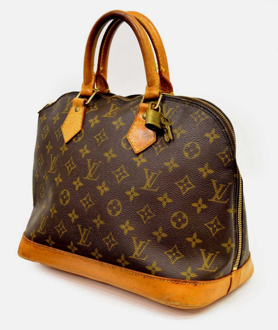 LOUIS VUITTON MONOGRAM CANVAS ALMA HANDBAG: Louis Vuitton "Alma" monogram canvas handbag, leather handles and trim, gold tone hardware, the dual zip opening to a canvas lined interior with slip pocket, accompanied by lock and key, some spotting