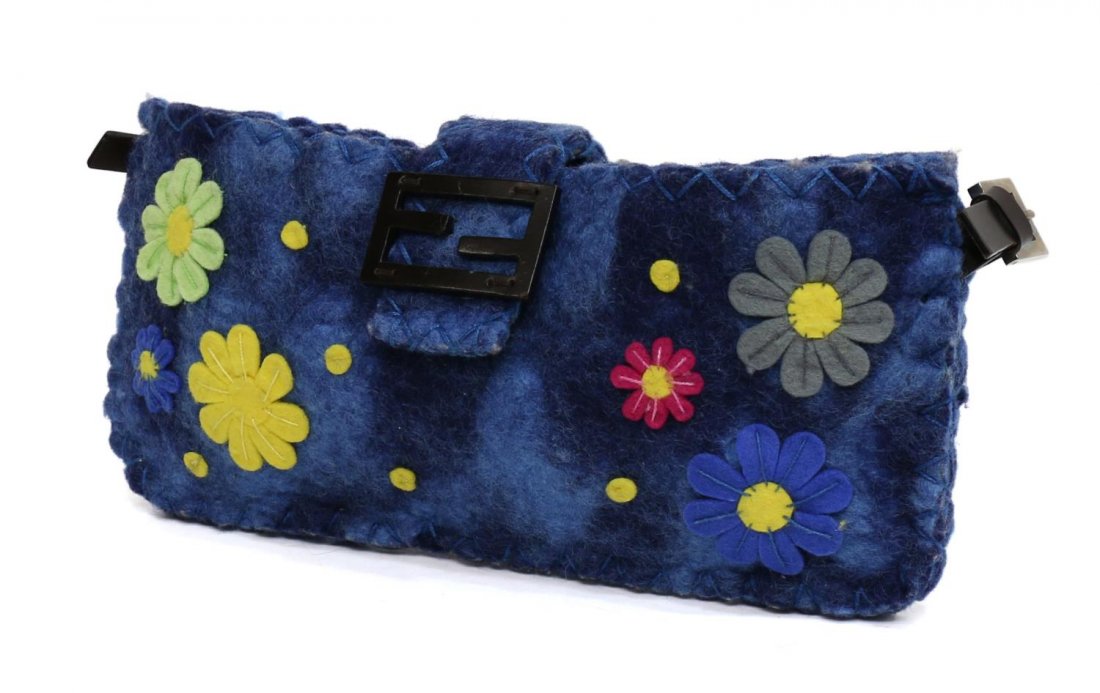 FENDI BLUE FELT FLORAL MOTFI HANDBAG PURSE: Fendi "Baguette" handbag in blue felt with sewn daisy motif, adjustable brown leather strap, silver tone hardware and magnetic snap closure, dust bag included, handbag: approx 6"h, 12"l, 1"w, .75lb St