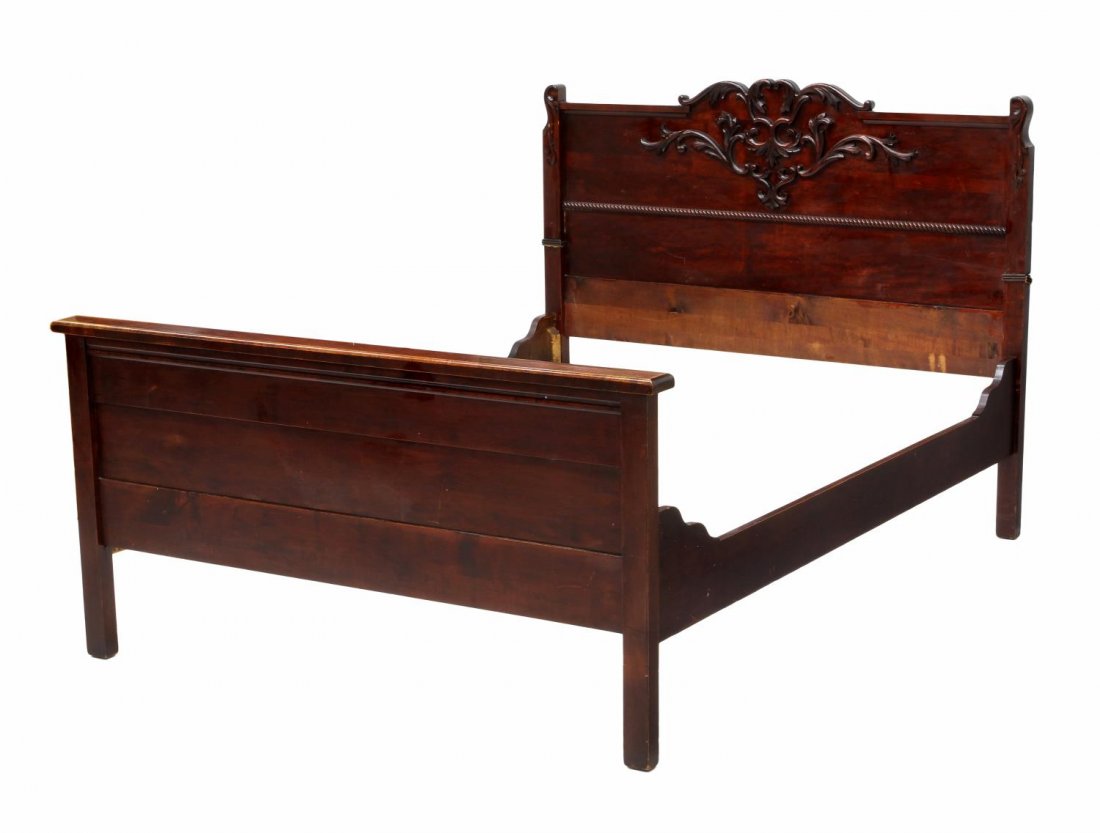 AMERICAN MAHOGANY FINISH BED, C. 1900: American mahogany finish bed, c. 1900, the headboard with a serpentine crest over applied foliate carving, headboard: 46.75"h, 57"w, inside: approx: 54"w, 74"l Start Price: $50.00