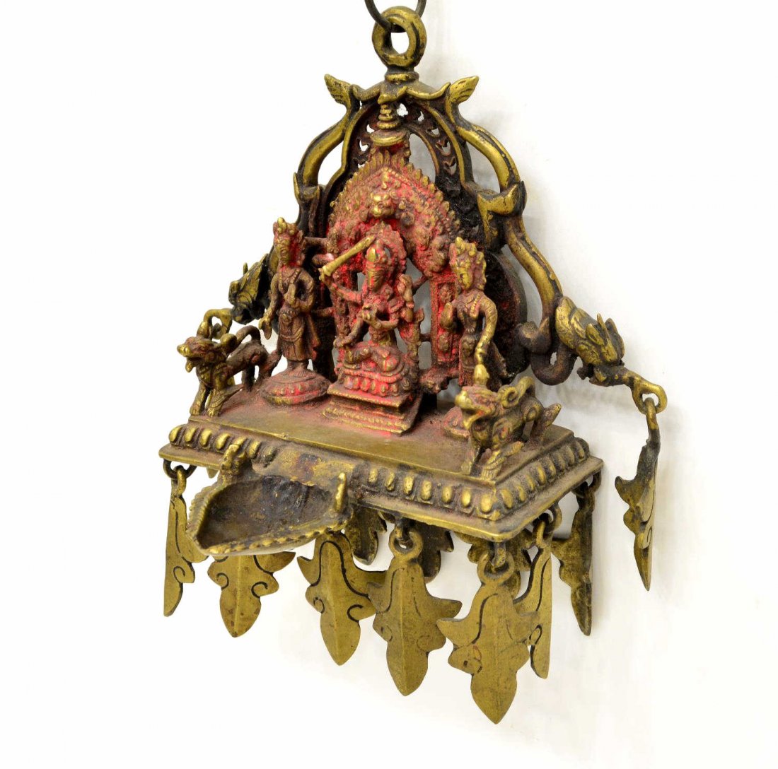 NEPALESE BRONZE DEEPA MANJUSHRI 19TH/20TH C.: A bronze deepa (lamp) depicting Manjushri and consorts with orignal bronze chain, Nepal, 19th/20th c., deepa (lamp) 6.5" h, 8.5" x 6", chain 24", lbs. Provenance: From a private collection, purchased 
