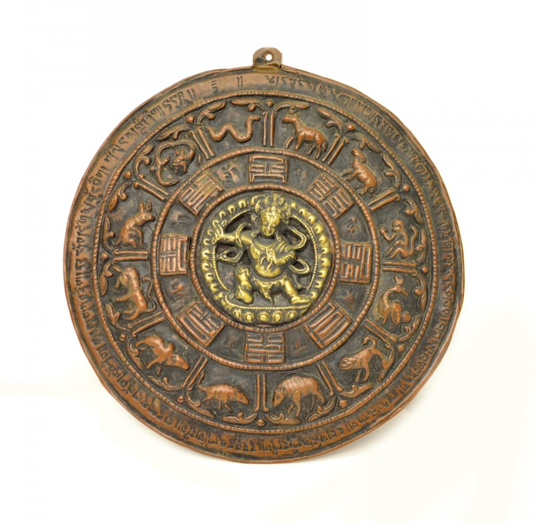 TIBETAN BRASS & COPPER RELIEF CALENDAR PLAQUE: Tibetan Buddhist brass and copper relief calendar plaque, inscribed on back in Tibetan script, 5.5" dia, .25 lbs Provenance: From a private collection Start Price: $80.00