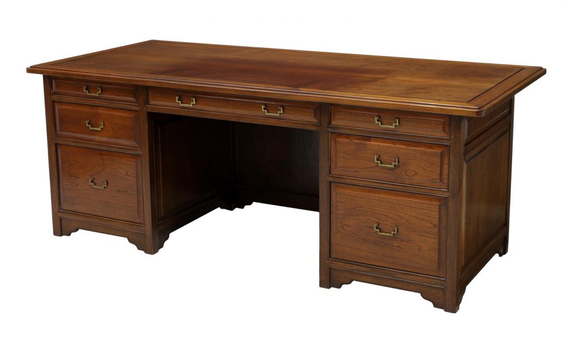 FINE CHINESE CARVED ELM / TEAKWOOD EXECUTIVE DESK: Mid-century Asian teakwood executive desk, the large rectangular top over hanging on client side, the paneled front carved with symbol in low relief, the back having an assortment of drawers, includin