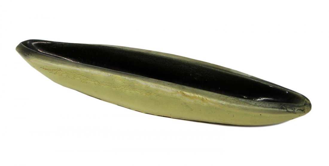 SCARCE SIGNED RUSSEL WRIGHT CANOE BOWL, 23"L: Scarce canoe form pottery bowl, design by Russel Wright for Bauer Pottery, jonquil and gunmetal blaze, signed at underside, 3"h, 23.5"l, 4.5"d Start Price: $100.00